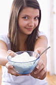 Girl holding a bowl of yoghurt