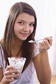 Girl holding yoghurt muesli