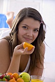 Girl holding half an orange
