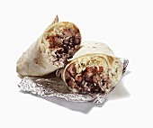 Rice and Bean Burrito Halved on Foil