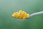 Sweetcorn kernels on spoon