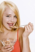 Young woman eating cornflakes