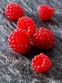 Several Japanese wineberries on a stone board