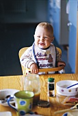 Baby in high chair at dining table