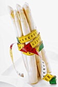 White asparagus wrapped in tape measure