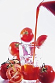 Pouring tomato juice into glass