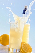 Lemonade splashing out of glass