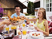 Family having breakfast out of doors