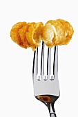 Potato croquette on fork, close-up