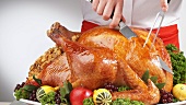 Carving roast turkey on festive table