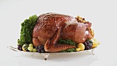Roast turkey with autumn decorations on silver platter