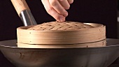 Lifting the lid of a bamboo basket
