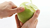 Peeling a green apple