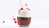 Serving chocolate cream with cream & redcurrants in a glass