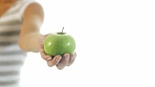 Young woman holding a green apple