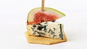 Blue cheese and fig on cocktail stick on cracker