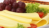 Cheese platter with grapes and salted sticks