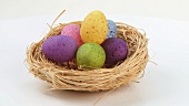 Coloured eggs in Easter nest