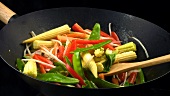 Stir-frying vegetables in a wok