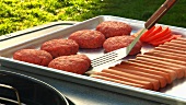 Burgers and sausages ready for grilling