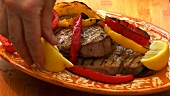 Grilled tuna steaks with pepper slices
