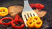 Grilling tuna steaks and pepper slices