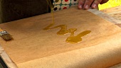 Brushing baking parchment with oil