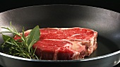 T-bone steak in a frying pan