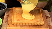 Spreading cheese mixture in pastry case