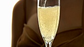 Pouring and drinking a glass of sparkling wine