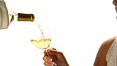 Pouring and drinking a glass of white wine