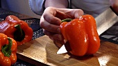 Halving and deseeding a red pepper