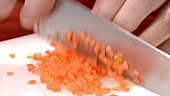 Dicing carrot sticks (close-up)