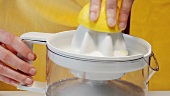 Squeezing a lemon with an electric citrus squeezer