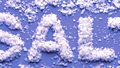 The word SALT written in sea salt flakes