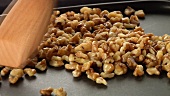 Walnuts being roasted in a pan