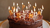 A chocolate birthday cake with candles