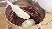 Folding cream into melted chocolate