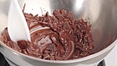 Melting chocolate coating over a pan of simmering water