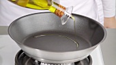 Pouring oil into a pan