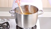 Stirring preserve in a saucepan