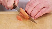 Finely chopping a skinned, deseeded tomato