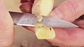 Peeling ginger root