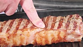 Doneness of New York strip steaks being tested