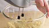 Biscuit dough being mixed with a hand mixer