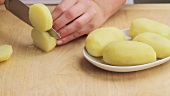 Cooked potatoes being sliced