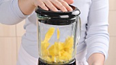 Mango being mixed in a blender