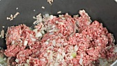 Onions and minced meat being fry