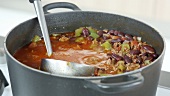 A ladle in a pot of chilli con carne