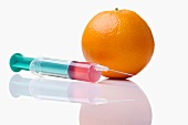 Syringe by orange, close-up